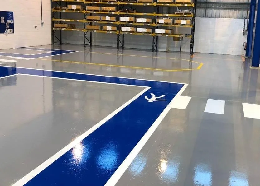 Industrial area with a continuous resin floor and blue-and-white traffic markings
