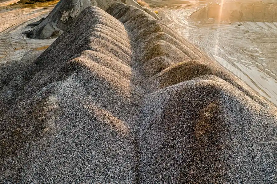 Sand and crushed stone stockpiles at a quarry